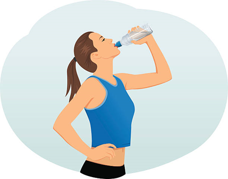 A fit girl is shown drinking water from a bottle. 
